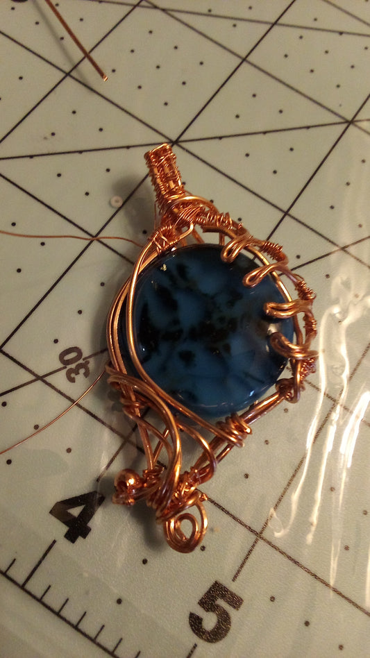 Wrapped copper blue glass cabochon